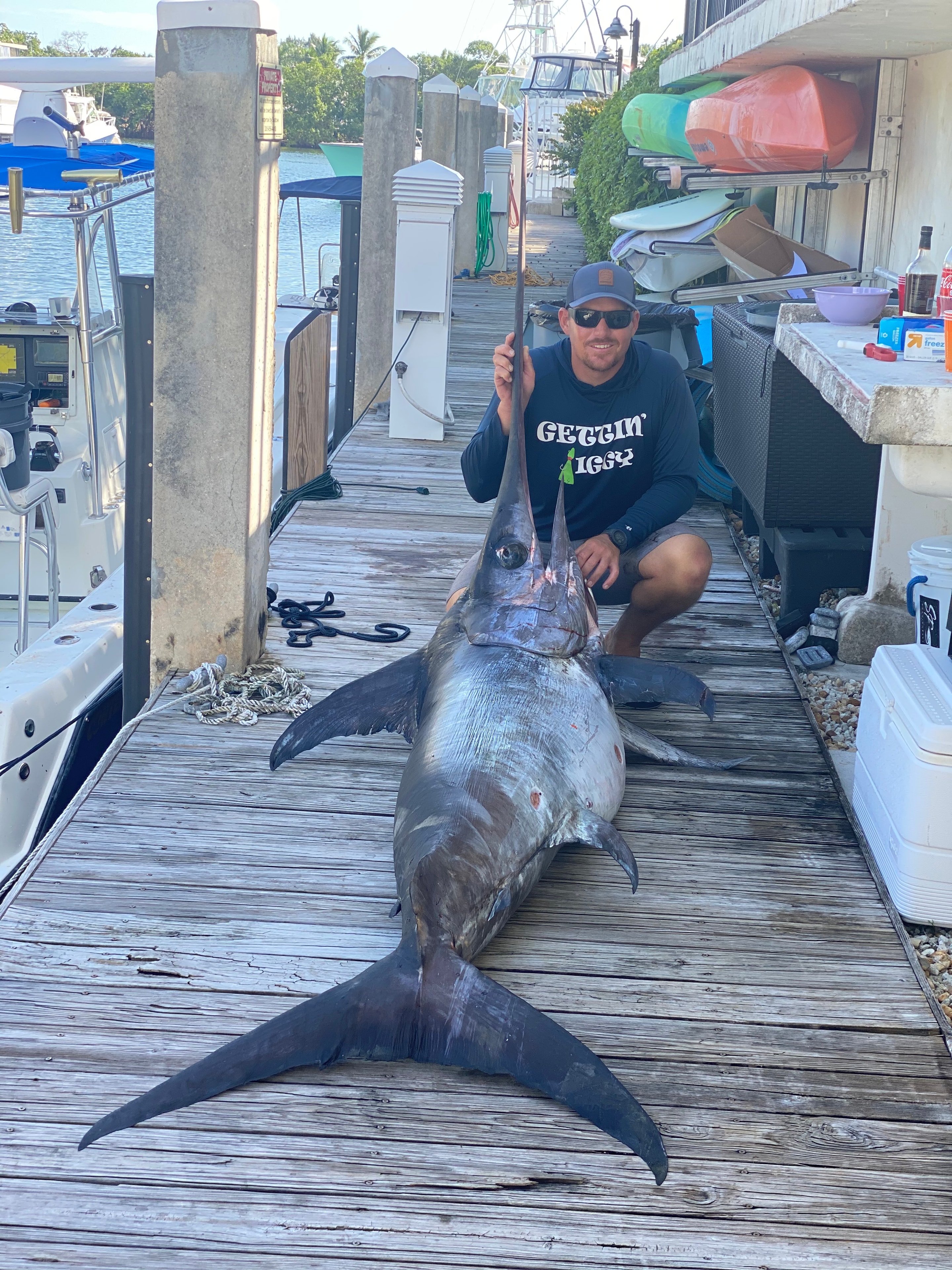 Captain Austin with a massive swordfish catch at the dock